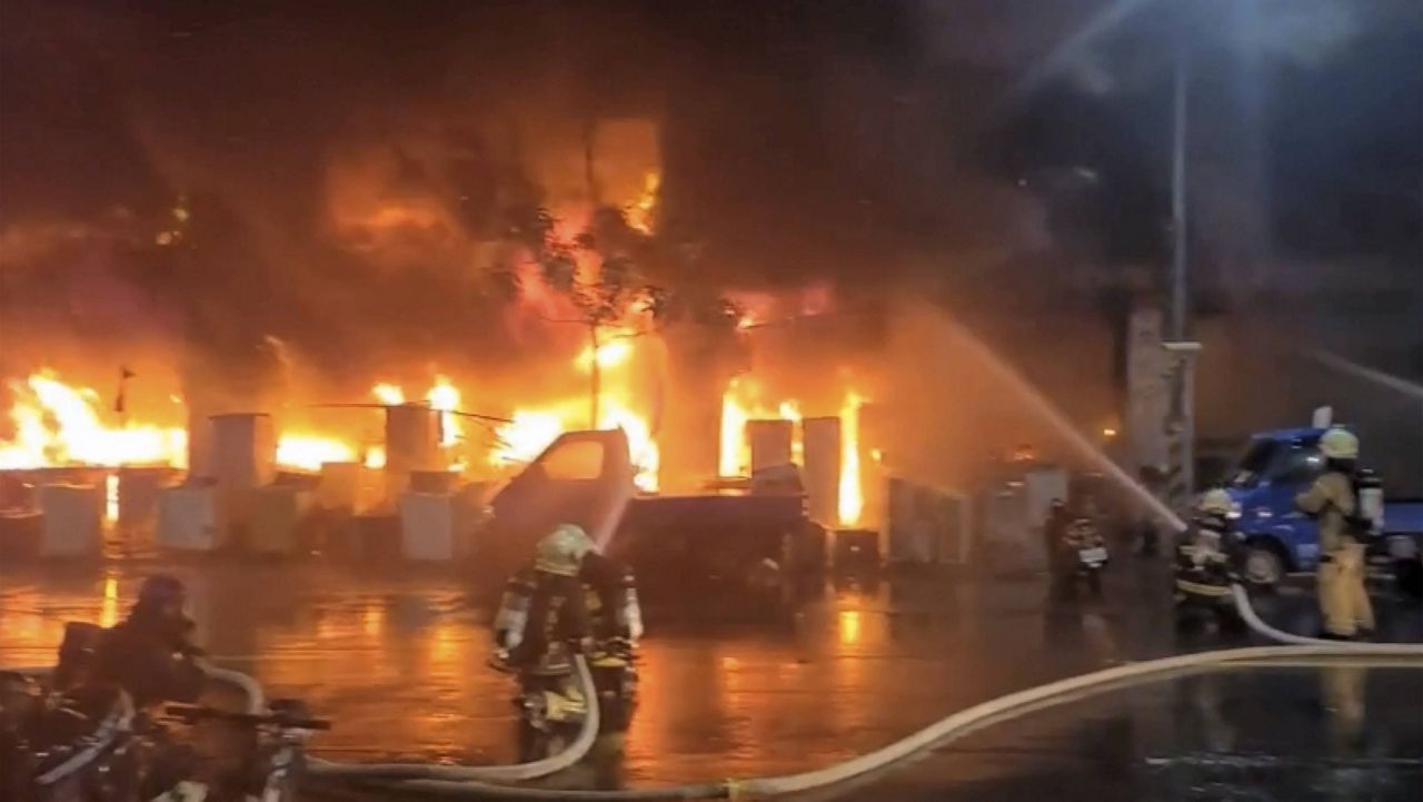 In this image taken from video by Taiwan's EBC, firefighters battle a blaze Thursday at a building in Kaohsiung, Taiwan. (EBC via AP)