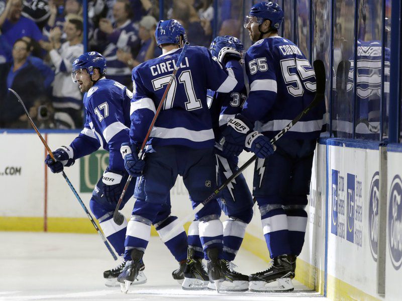 Tampa Bay Lightning left wing Alex Killorn (17) celebrates his goal against the New Jersey Devils with teammates, including Anthony Cirelli (71) and Braydon Coburn (55), during the third period of Game 1 of an NHL first-round hockey playoff series Thursday, April 12, 2018, in Tampa, Fla. The Lightning won 5-2. (AP Photo/Chris O’Meara)