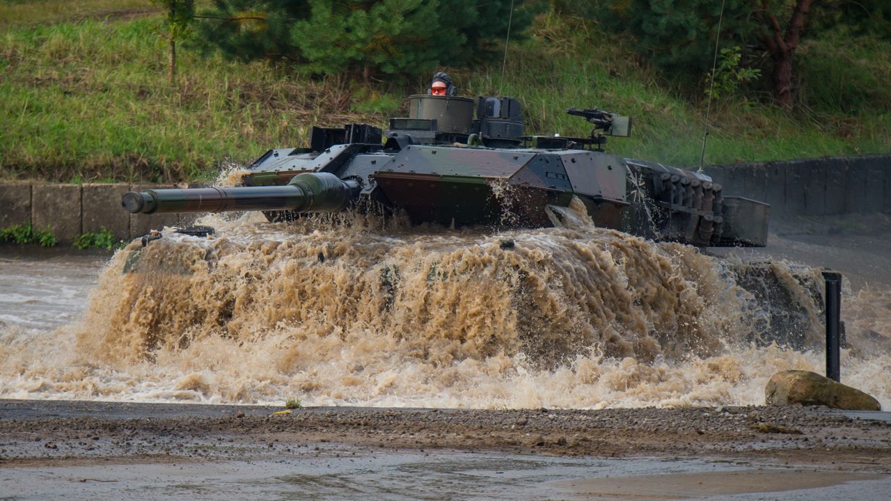A Leopard 2A6 main battle tank drives through a pool of water during preparations for the Land Operations 2017 information training exercise in Munster, Germany, on Sept 25, 2017. (Philipp Schulze/dpa via AP, file)