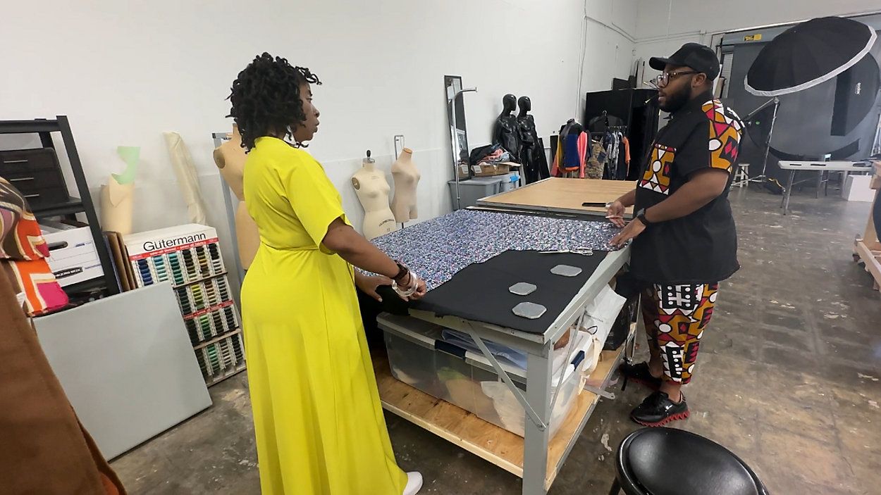 Woven Fashion Incubator founder and fashion designer Tara Davis [left] is assisting designer Jamie Lykes with a half skirt. Davis' students call her an Everyday Hero for all she does with helping fashion dreams come true (Spectrum News 1/Jennifer Roberts). 