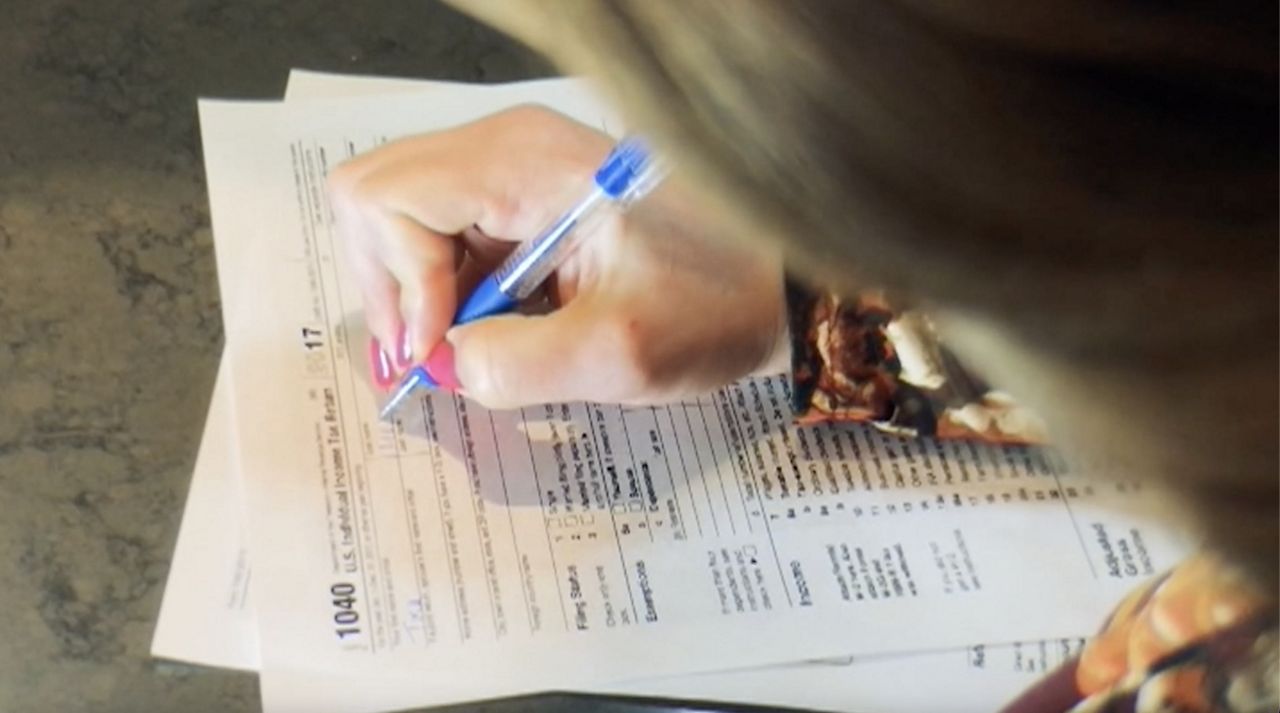 woman penning tax return