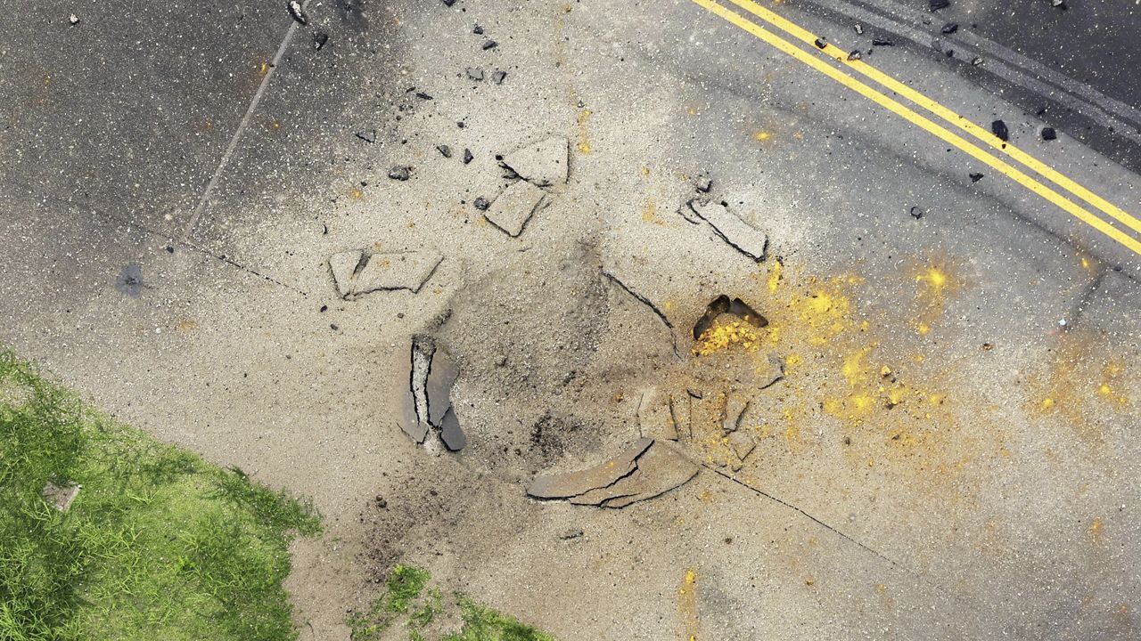 This photo taken from a Kyodo News helicopter shows part of a damaged taxiway at Miyazaki Airport in southwestern Japan, Wednesday, Oct. 2, 2024, after an explosion was reported. (Kyodo News via AP)