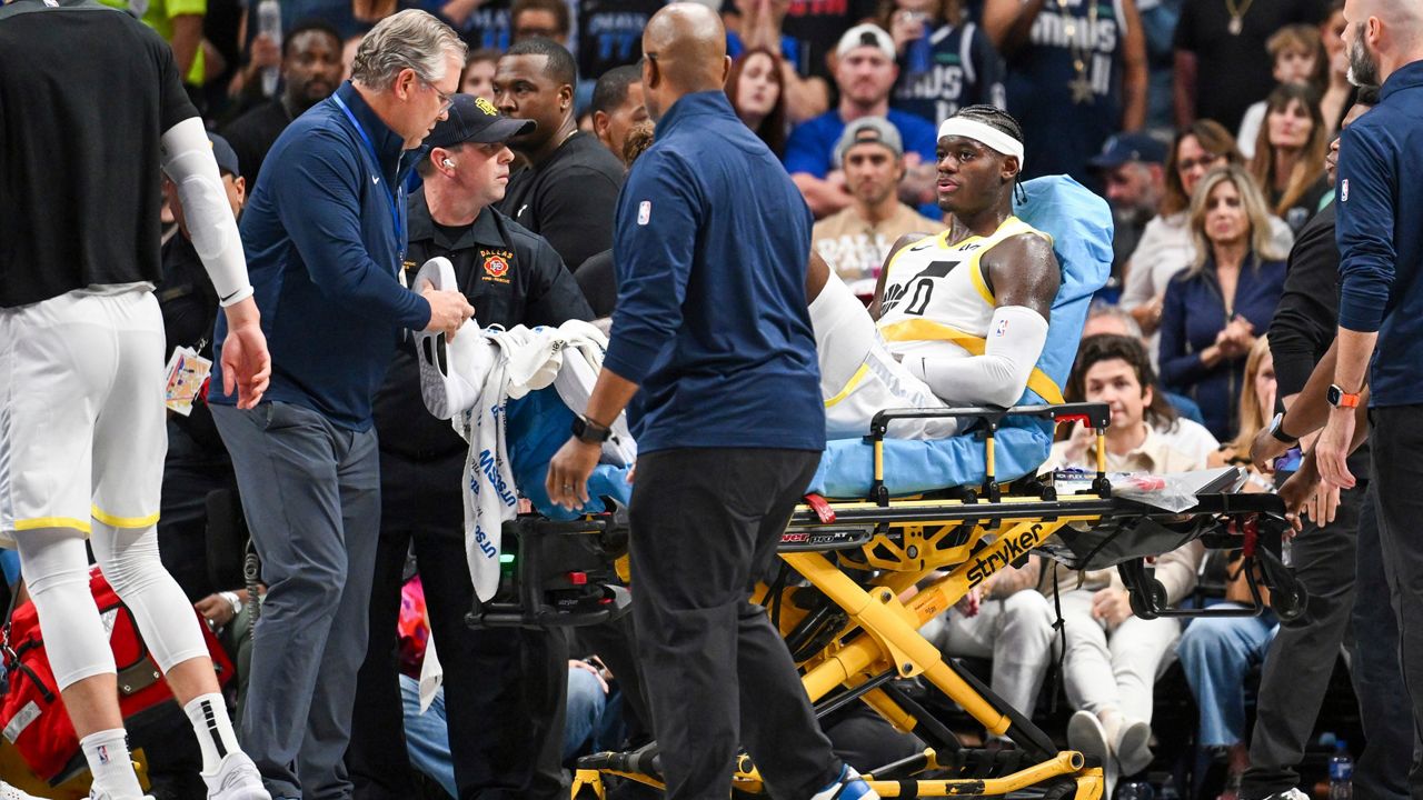 Jazz forward Taylor Hendricks (0), a former standout at UCF, is wheeled off by paramedics after sustaining an injury in an NBA basketball game against the Mavericks on Monday, Oct. 28, 2024, in Dallas. (AP Photo/Albert Pena)