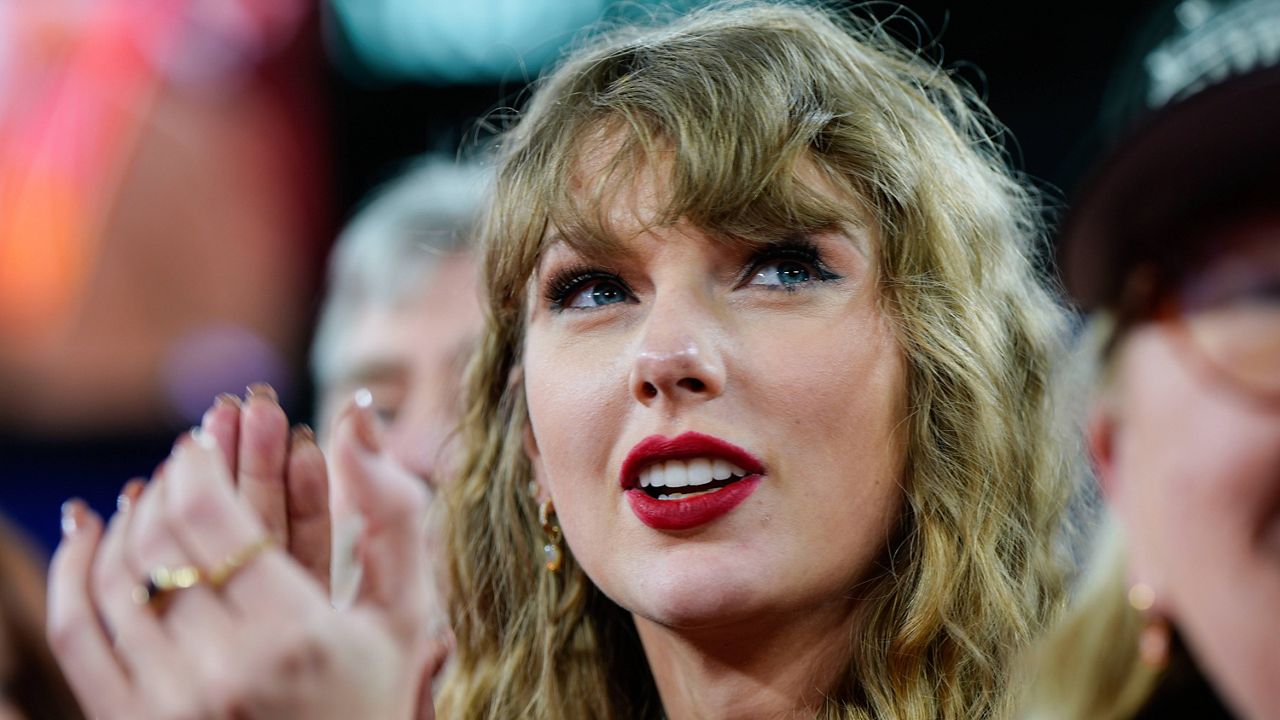 Taylor Swift stands on the field after an AFC Championship NFL football game between the Baltimore Ravens and the Kansas City Chiefs, Sunday, Jan. 28, 2024, in Baltimore. (AP Photo/Julio Cortez, File)