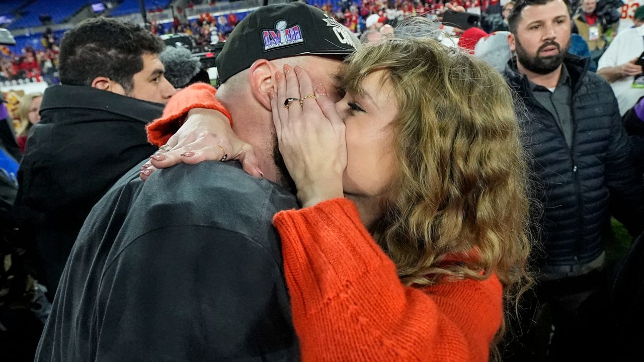 Taylor Swift speaks with Kansas City Chiefs tight end Travis Kelce after an AFC Championship NFL football game against the Baltimore Ravens, Sunday, Jan. 28, 2024, in Baltimore. The Kansas City Chiefs won 17-10. (AP Photo/Julio Cortez)