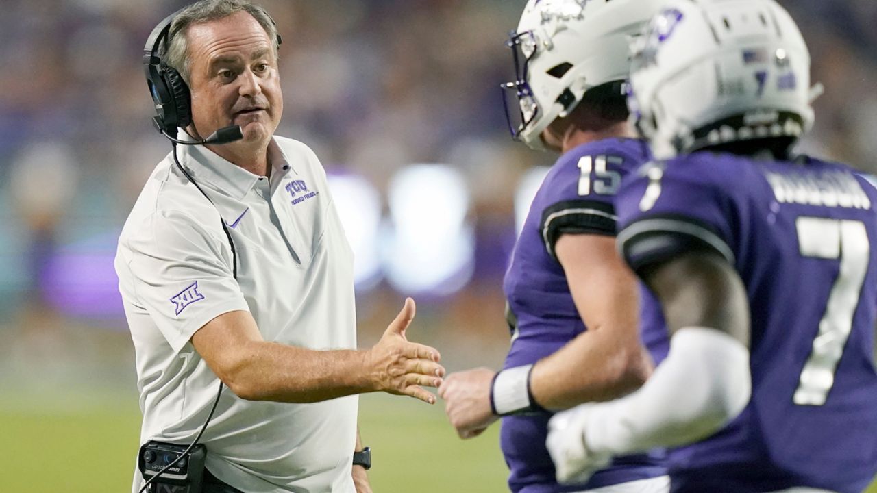 TCU head coach Sonny Dykes, left, congratulates quarterback Max Duggan (15) after a touchdown during the first half of an NCAA college football game against Tarleton State in Fort Worth, Texas, Saturday, Sept. 10, 2022. (AP Photo/LM Otero)