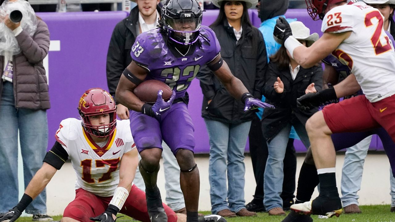 TCU running back Kendre Miller beats Iowa State defenders Beau Freyler (17) and Will McLaughlin on his way to score a touchdown during the first half of an NCAA college football game in Fort Worth, Texas, Saturday, Nov. 26, 2022. (AP Photo/LM Otero)