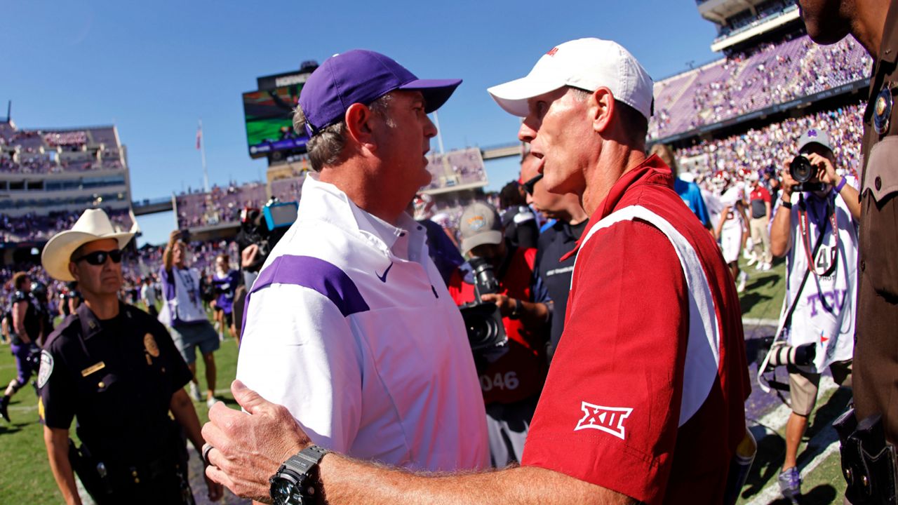 TCU head coach Sonny Dykes, left, meets Oklahoma head coach Brent Venables on the field following TCU's 55-24 win over Oklahoma in an NCAA college football game Saturday, Oct. 1, 2022, in Fort Worth, Texas. (AP Photo/Ron Jenkins)