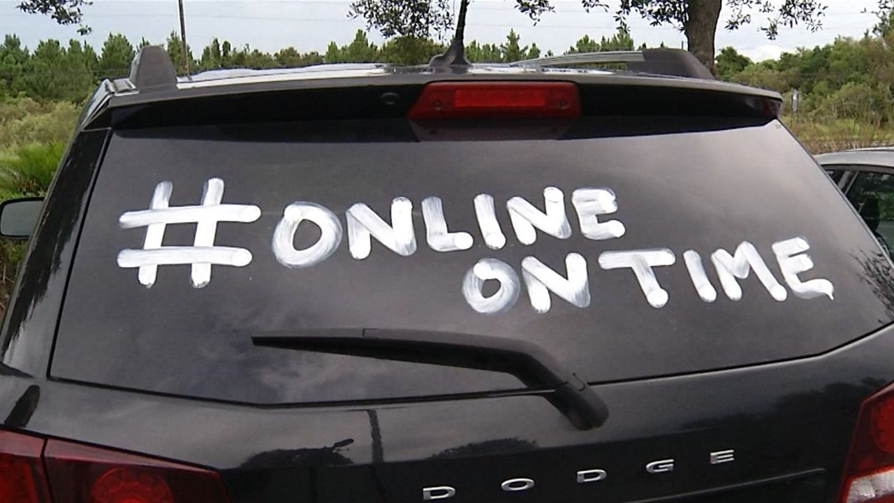 The hashtag "online on time" is painted on a teacher's car in Pasco County (Spectrum News)