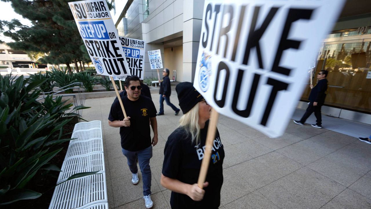 Members with Teamsters Local 2010 join the California Faculty Association (CFA) and other California State University (CSU) unions at a rally outside the CSU Chancellor's Office in Long Beach, Calif., on Nov. 14, 2023. (AP Photo/Damian Dovarganes)