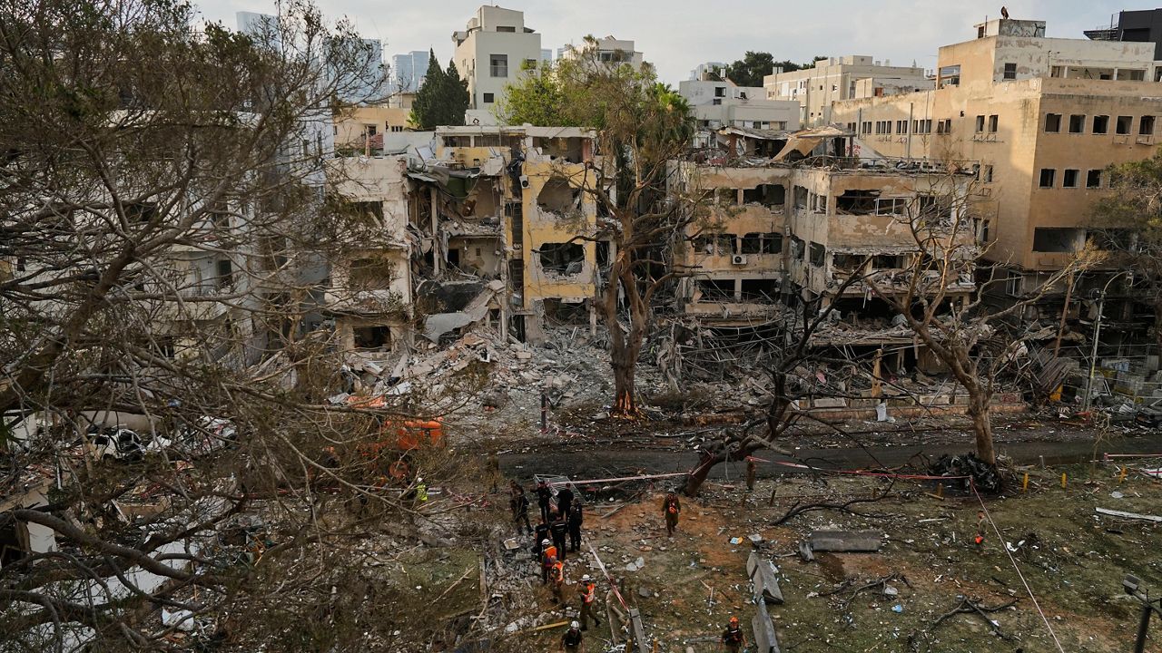 Rescue team work at the site where a missile launched from Iran struck Tel Aviv, Israel, Monday, June 16, 2025. (AP Photo/Baz Ratner)
