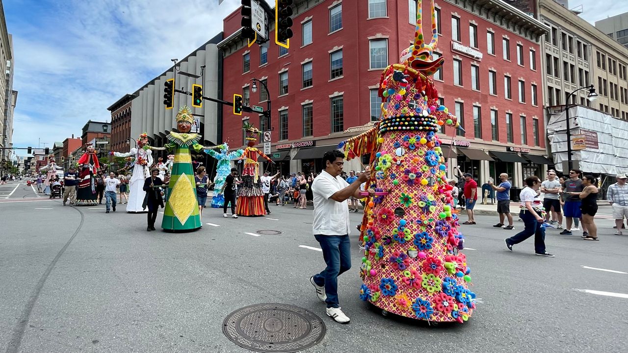 Parade participants make their way down Main Street in Downtown Worcester.