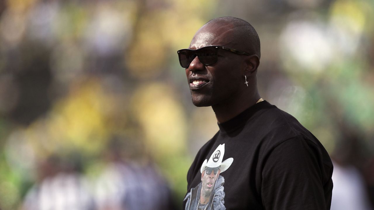 Former NFL football player Terrell Owens looks on during warm-ups before an NCAA football game between Colorado and Oregon, Saturday, Sept. 23, 2023, in Eugene, Ore. (AP Photo/Amanda Loman)