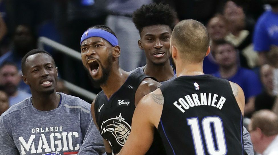 Orlando Magic's Terrence Ross, second from left, celebrates after sinking a 3-point shot against the Philadelphia 76ers with Jerian Grant, left, Jonathan Isaac, second from right, and Evan Fournier (10) in the finals moments of an NBA basketball game Wednesday, Nov. 14, 2018, in Orlando, Fla. (AP Photo/John Raoux)