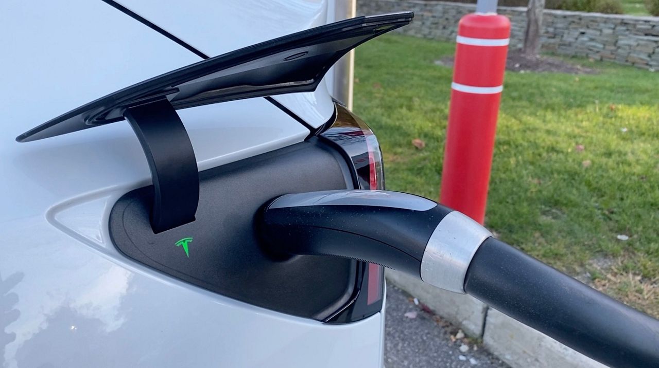 A Tesla vehicle is recharged at a charging station in this file image. (Spectrum News/FILE)