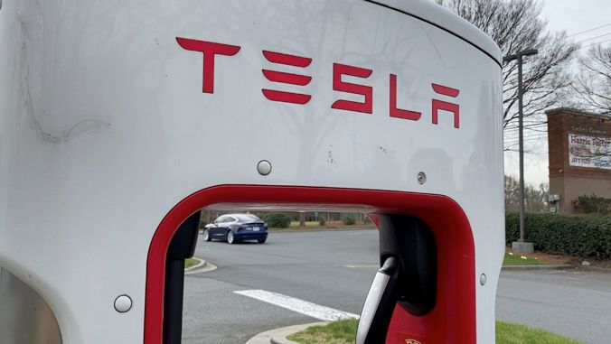 Tesla Supercharger in a parking lot. (AP Images)