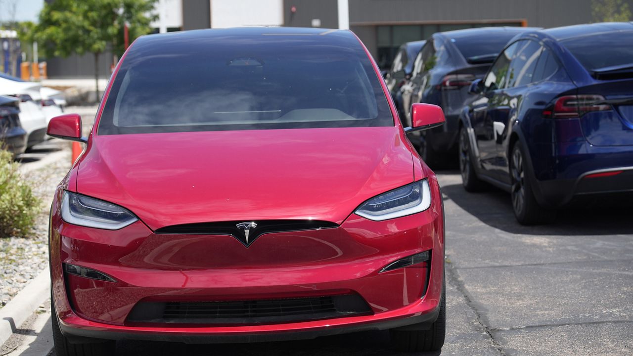 Unsold 2023 Model X sports-utility vehicles sit at a Tesla dealership, June 18, 2023, in Littleton, Colo. (AP Photo/David Zalubowski)