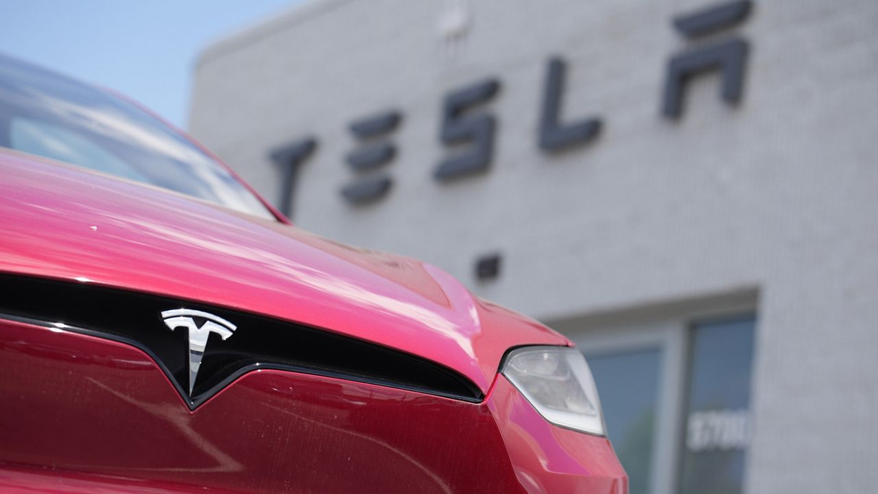 A Model X sports-utility vehicle sits outside a Tesla store in Littleton, Colo., June 18, 2023. (AP Photo/David Zalubowski, File)