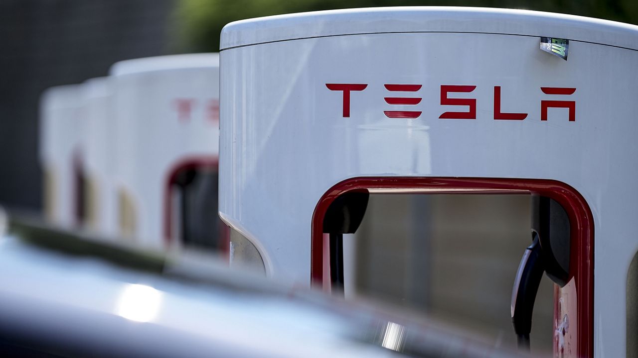 A Tesla charging station is seen, Sept. 28, 2023, in Woodstock, Ga. Tesla knocked roughly a third off the price of its “Full Self Driving” system, which can’t drive itself and so drivers must remain alert and be ready to intervene, to $8,000 from $12,000, according to the company website. (AP Photo/Mike Stewart, File)