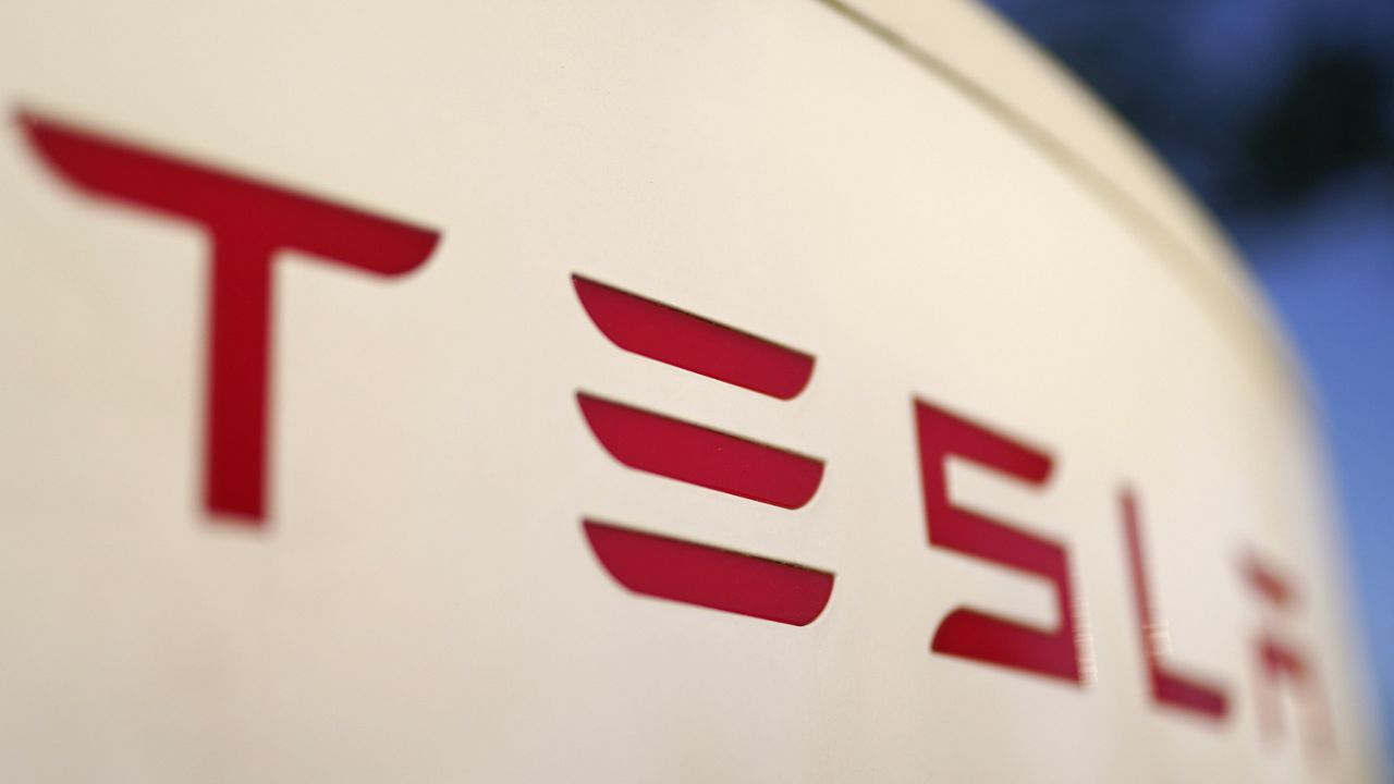 The logo for the Tesla Supercharger station is seen in Buford, Ga, April 22, 2021. Two men are accused of starting a business in China using battery manufacturing technology pilfered from Tesla and trying to sell the proprietary information, federal prosecutors in New York said Tuesday, March 19, 2024. (AP Photo/Chris Carlson, File)