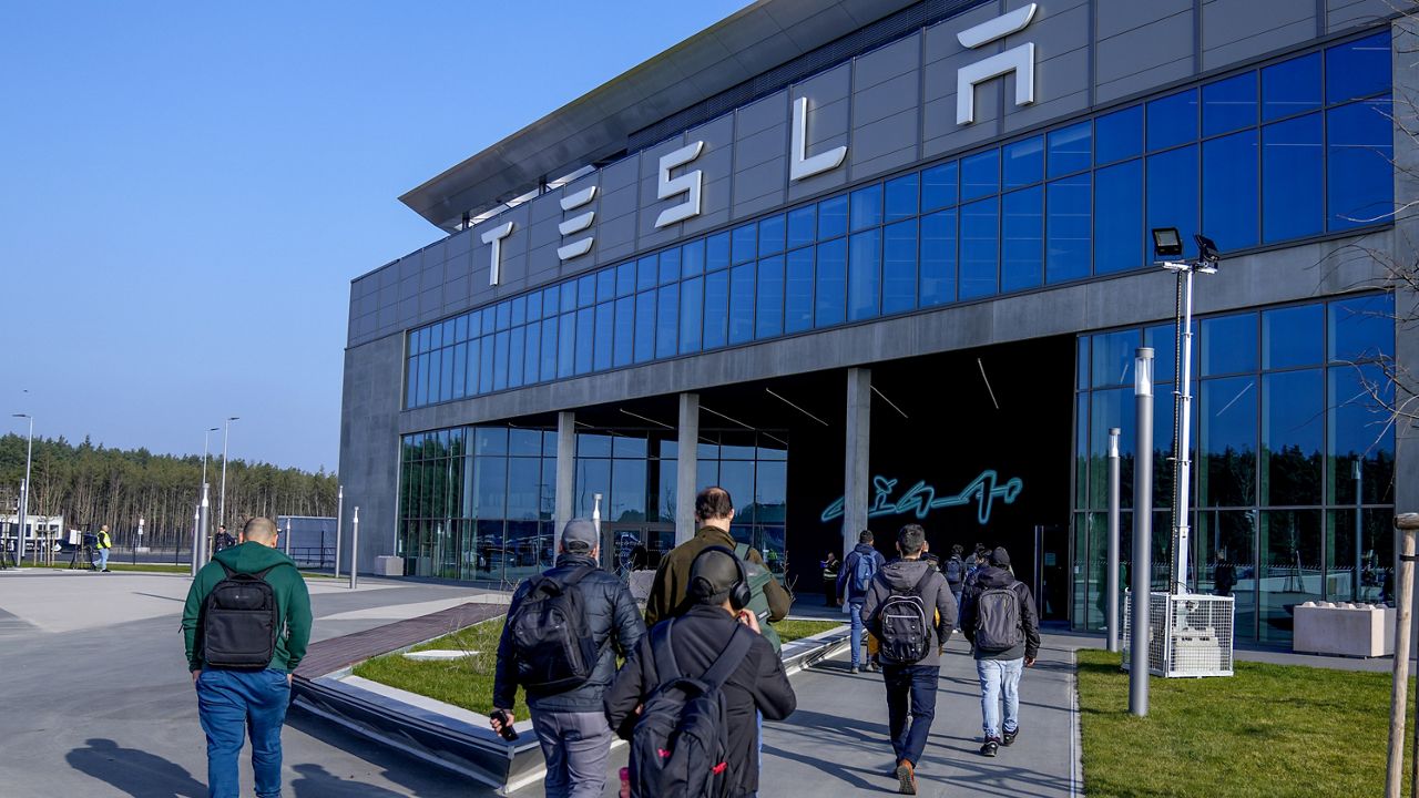 People walk to the Tesla Gigafactory for electric cars in Gruenheide near Berlin, Germany,March 13, 2024. After reporting dismal first-quarter sales, Tesla is planning to lay off about a tenth of its workforce as it tries to cut costs, multiple media outlets reported Monday. (AP Photo/Ebrahim Noroozi, File)