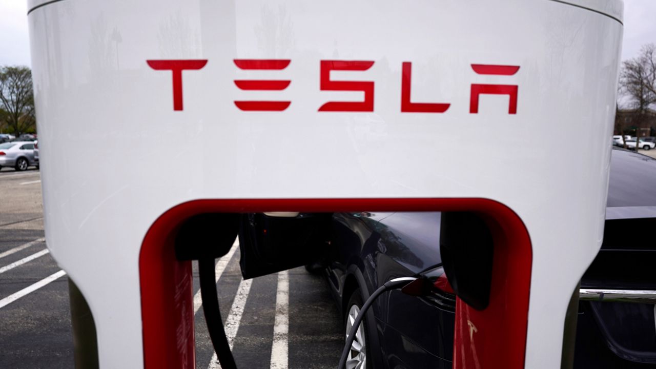 Tesla Supercharger is seen at Willow Festival shopping plaza parking lot in Northbrook, Ill., on May 5, 2022. (AP Photo/Nam Y. Huh, File)