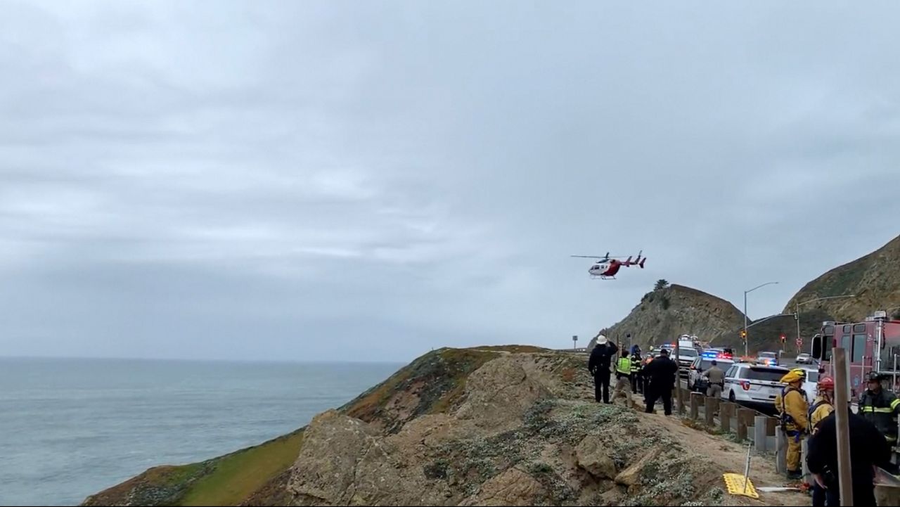 This image from video provided by Cal Fire San Mateo, Santa Cruz Unit, emergency personnel respond to the scene after a Tesla plunged off a cliff along the Pacific Coast Highway, Monday. (Cal Fire San Mateo - Santa Cruz Unit via AP, File)
