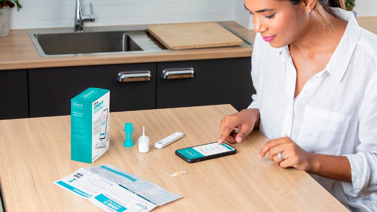 A woman uses the at-home, rapid coronavirus test authorized by the FDA Tuesday. (Courtesy Ellume Health)