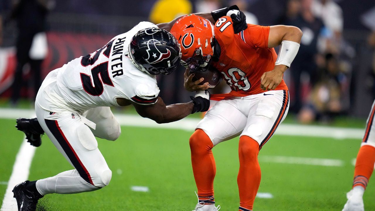 Chicago Bears quarterback Caleb Williams, right, is grabbed by Houston Texans defensive end Danielle Hunter (55) during the second half of an NFL football game Sunday, Sept. 15, 2024, in Houston. (AP Photo/Eric Christian Smith)