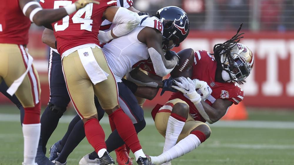 San Francisco 49ers outside linebacker Marcell Harris, right, is tackled by Houston Texans wide receiver Chris Conley while returning an interception during the second half of an NFL football game in Santa Clara, Calif., Sunday, Jan. 2, 2022. (AP Photo/Jed Jacobsohn)