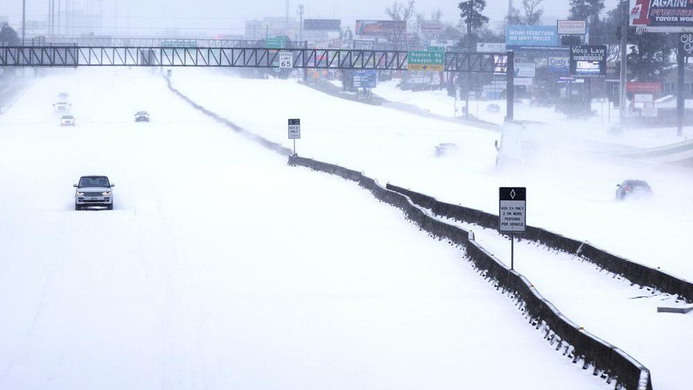 FILE - In this Monday, Feb. 15, 2021 file photo, Traffic is sparse on the snow-covered Interstate 45 near The Woodlands Parkway following an overnight snowfall in The Woodlands, Texas, as temperatures plunged into the teens with light snow and freezing rain. A study published in the journal Science on Thursday, Sept. 2, 2021, is the first to show physical connections between climate change and the Valentine's Week 2021 extreme cold. (Brett Coomer/Houston Chronicle via AP)