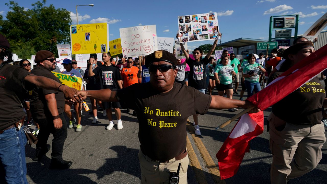 Escorted by the Texas Brown Berets, family and friends of those killed and injured in the school shootings at Robb Elementary take part in a protest march and rally, Sunday, July 10, 2022, in Uvalde, Texas. Families and residents are seeking answers and changes after the tragedy. (AP Photo/Eric Gay)