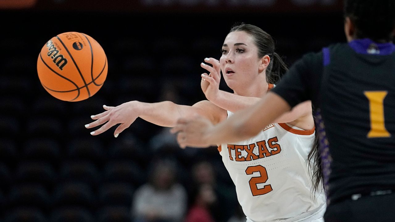 Texas guard Shaylee Gonzales (2) pass the ball past East Carolina guard Micah Dennis (1) during the second half of a first-round college basketball game in the NCAA Tournament in Austin, Texas, Saturday, March 18, 2023. (AP Photo/Eric Gay)