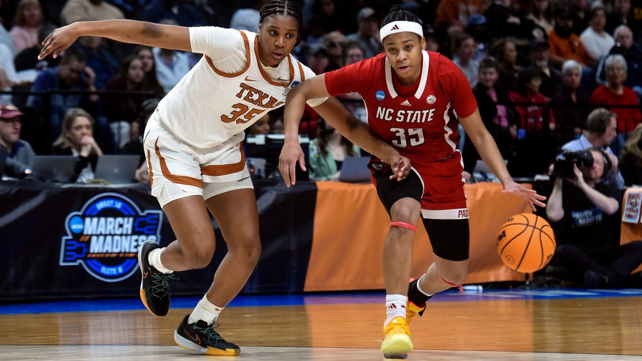 N.C. State guard Zoe Brooks (35) tries to get around Texas forward Madison Booker (35) during the first half of an Elite Eight college basketball game in the women's NCAA Tournament, Sunday, March 31, 2024, in Portland, Ore. (AP Photo/Steve Dykes)