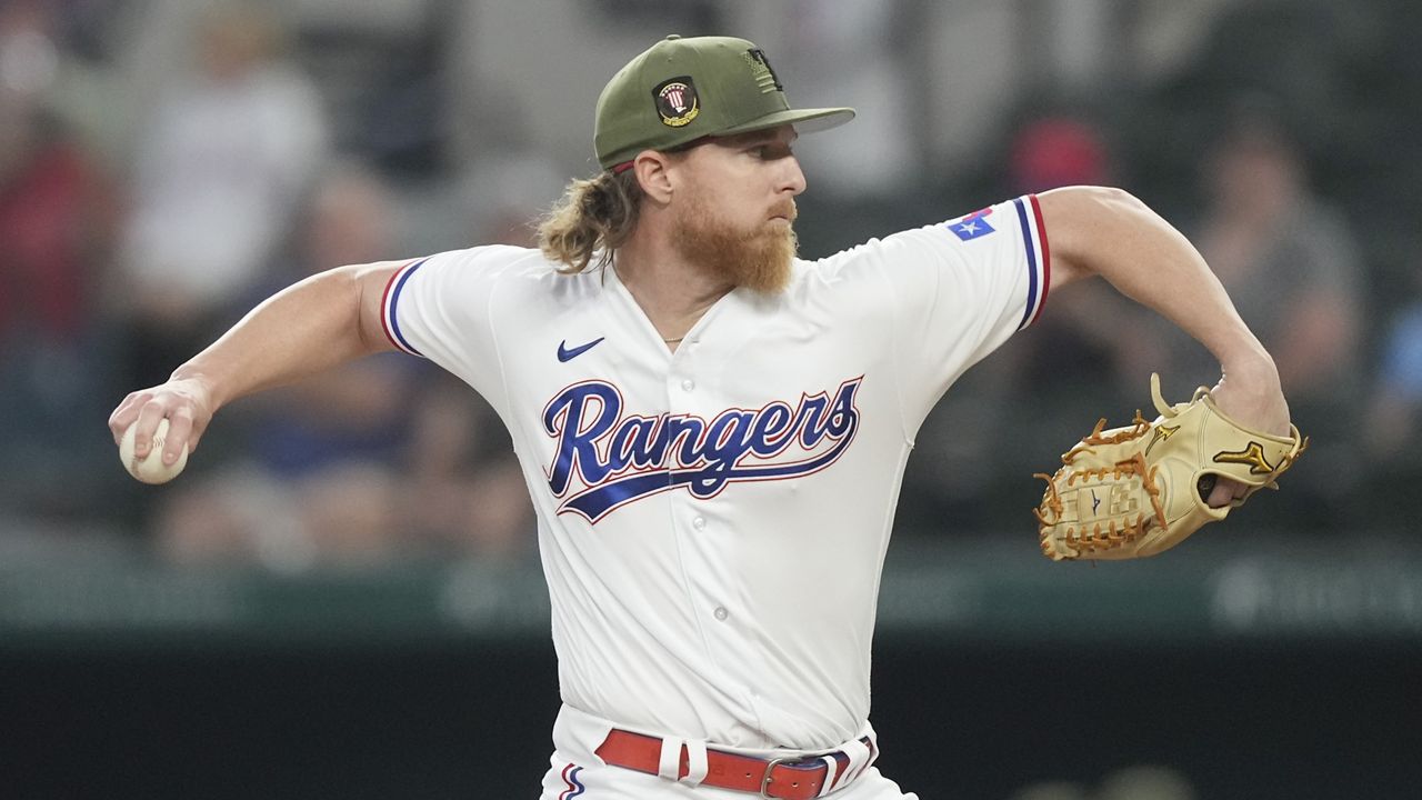 Marcus Semien of the Texas Rangers throws to first base in the