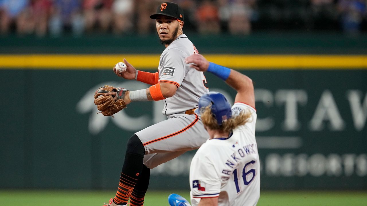 San Francisco Giants second baseman Thairo Estrada forces Texas Rangers' Travis Jankowski (16) before throwing to first on a fielders choice by Leody Taveras in the third inning of a baseball game, Saturday, June 8, 2024, in Arlington, Texas. Taveras was safe at first on the play. (AP Photo/Tony Gutierrez)