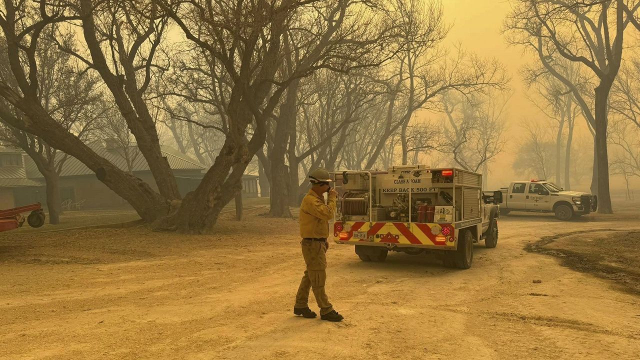 In this photo provided by the Flower Mound, Texas, Fire Department, Flower Mound firefighters respond to a fire in the Texas Panhandle, Tuesday, Feb. 27, 2024. A rapidly widening Texas wildfire doubled in size Tuesday and prompted evacuation orders in at least one small town. (Flower Mound Fire Department via AP)