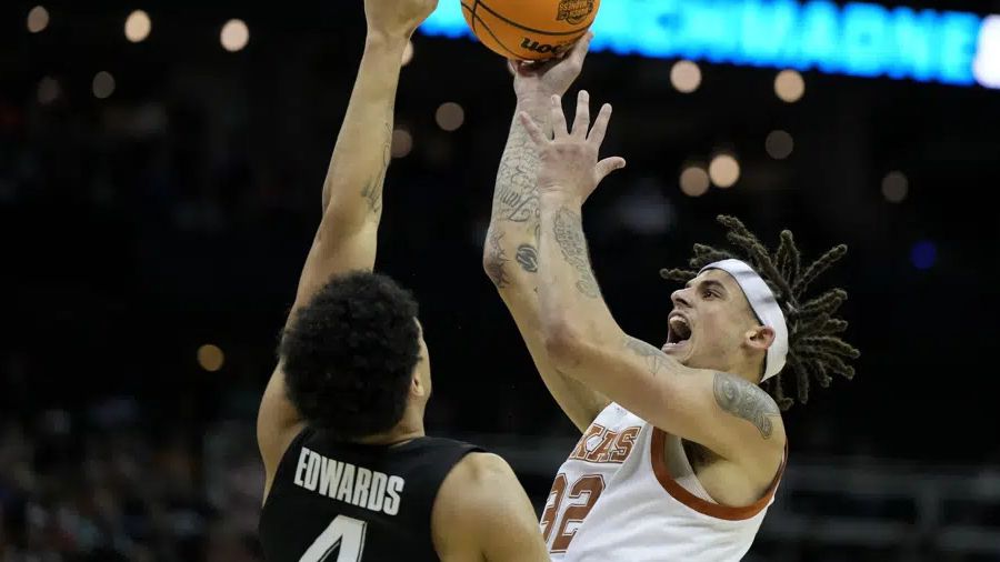 Texas forward Christian Bishop shoots over Xavier forward Cesare Edwards in the first half of a Sweet 16 college basketball game in the Midwest Regional of the NCAA Tournament Friday, March 24, 2023, in Kansas City, Mo. (AP Photo/Jeff Roberson)