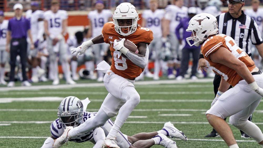 Texas wide receiver Xavier Worthy (8) runs past Kansas State defensive back Ekow Boye-Doe (25) during the first half of an NCAA college football game in Austin, Texas, Friday, Nov. 26, 2021. (AP Photo/Chuck Burton)