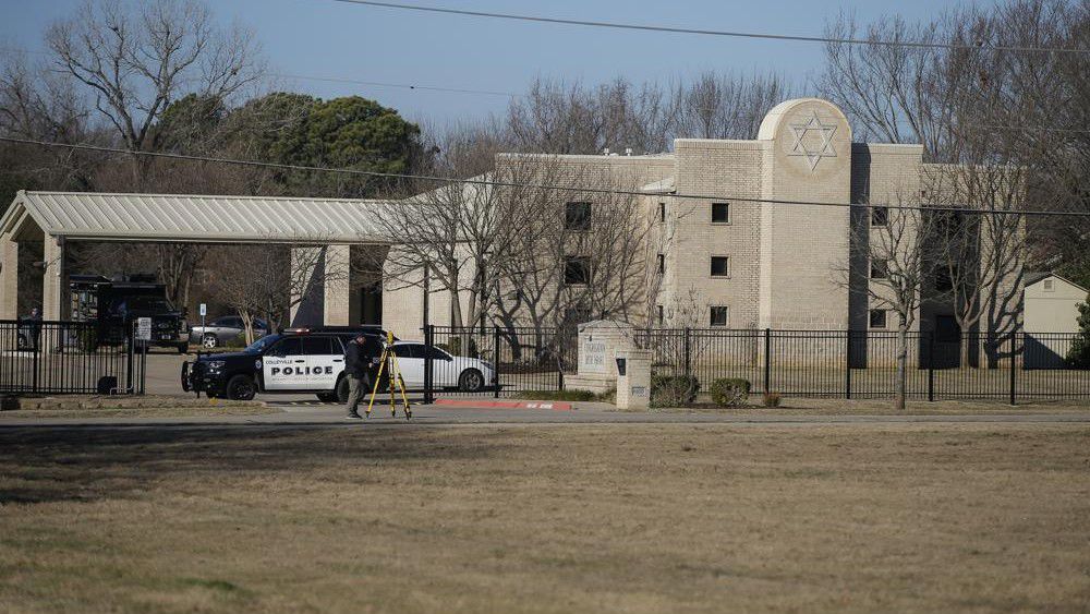 Law enforcement process the scene in front of the Congregation Beth Israel synagogue, Sunday, Jan. 16, 2022, in Colleyville, Texas. A man held hostages for more than 10 hours Saturday inside the temple.(AP Photo/Brandon Wade)