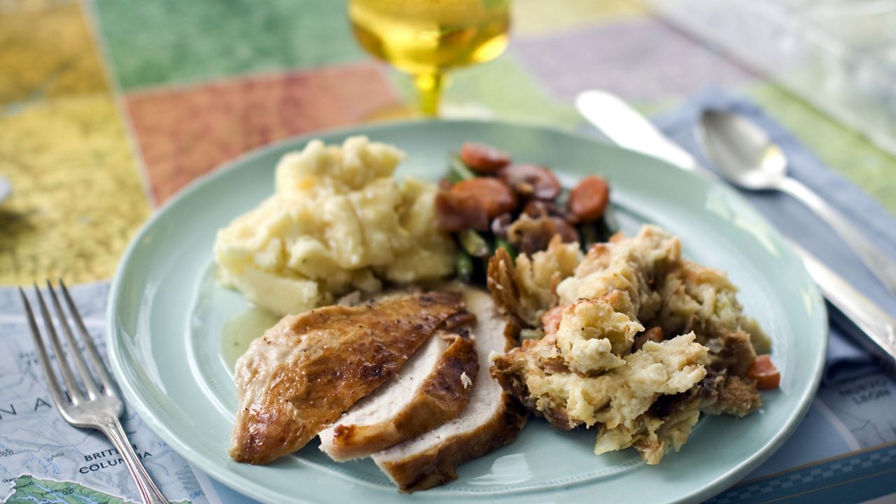 A plate of roasted turkey and gravy, stuffing, mashed potatoes, and glazed carrots (AP Photo/Matthew Mead, File)