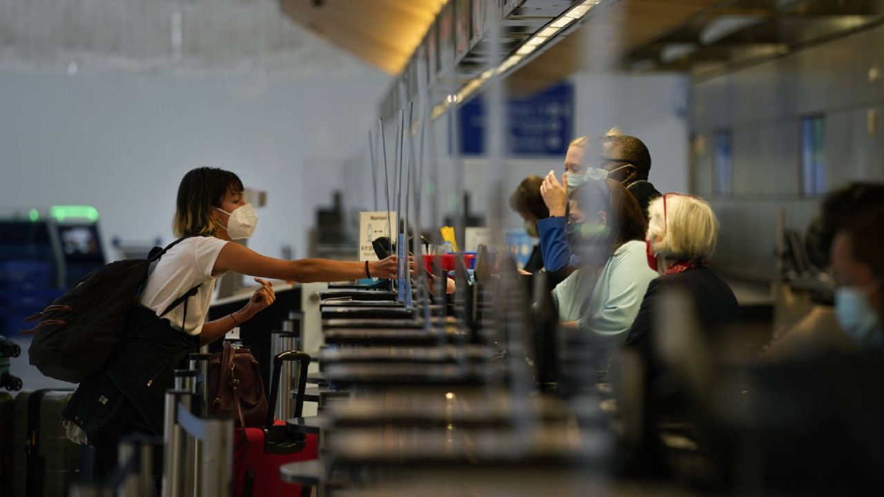 A woman checks in for her flight in Los Angeles Monday. (AP Photo/Jae C. Hong)