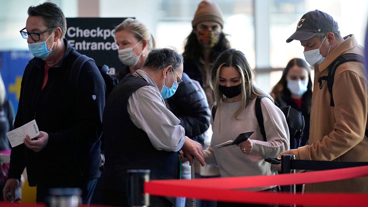 Travelers enter a security checkpoint at Logan International Airport in Boston on Wednesday. (AP Photo/Steven Senne)
