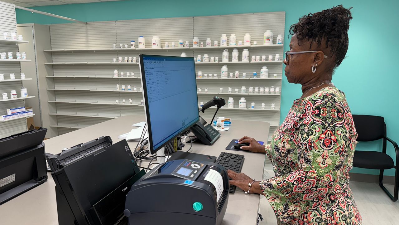 Pharmacist Jennifer Bradley gets the new pharmacy at The Center Orlando on Mills Avenue ready to serve clients. (Spectrum News/Sarah Winkelmann)