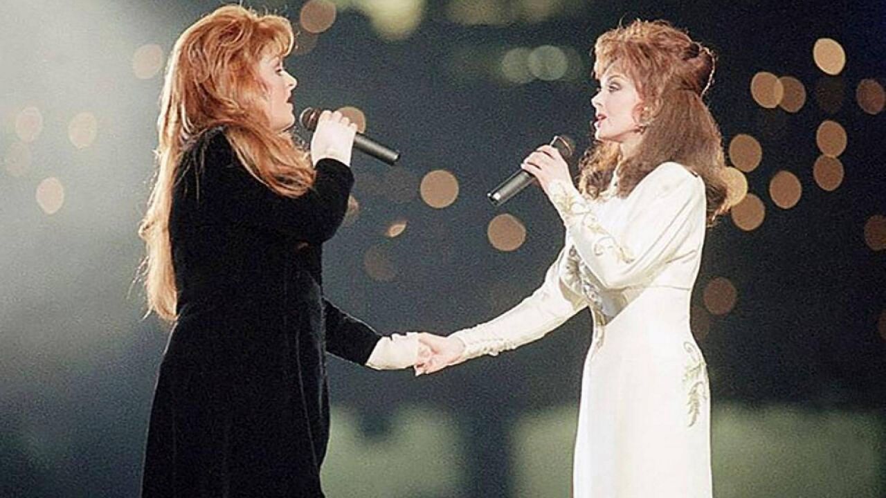 Wynonna Judd, left, and her mother, Naomi Judd, of The Judds, perform during the halftime show at Super Bowl XXVII in Atlanta on Jan 30, 1994. Naomi Judd, the Kentucky-born matriarch of the Grammy-winning duo The Judds and mother of Wynonna and Ashley Judd, had died, her family announced Saturday, April 30, 2022. she was 76. (AP Photo/Eric Draper)