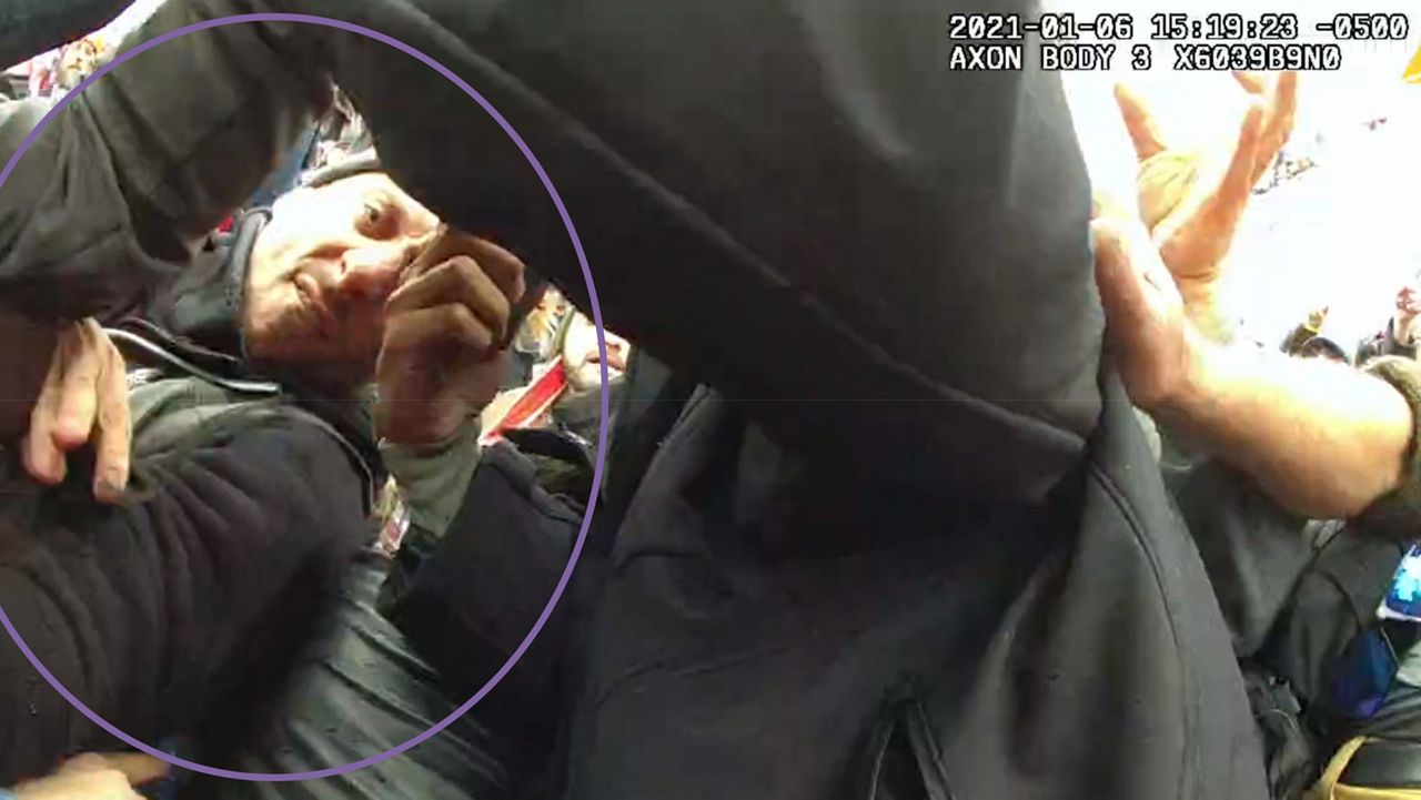 This image from the body-worn camera of Washington Metropolitan Police Department officer Michael Fanone shows Thomas Sibick, circled by the Justice Department, at left, during the riot at the U.S. Capitol on Jan. 6. Sibick pleaded guilty on Friday, March 3, 2023, to assault and theft charges for his role in the attack on Fanone. U.S. District Judge Amy Berman Jackson is scheduled to sentence Sibick on July 28. (Justice Department via AP)