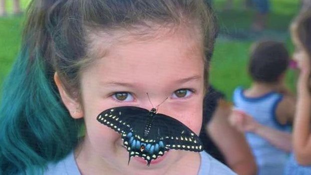 girl with butterfly on nose