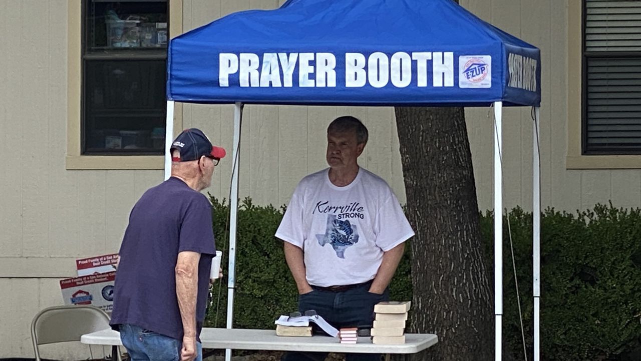 Guy Overby mans a prayer booth at First Baptist Church in Kerrville, Texas, where a FEMA Disaster Recovery Center has been set up to help people. (Spectrum)