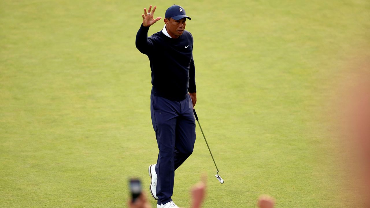 Tiger Woods acknowledges the gallery after a birdie putt on the 18th hole during the first round of the Genesis Invitational golf tournament at Riviera Country Club, Thursday, Feb. 16, 2023, in the Pacific Palisades area of Los Angeles. (AP Photo/Ryan Kang)
