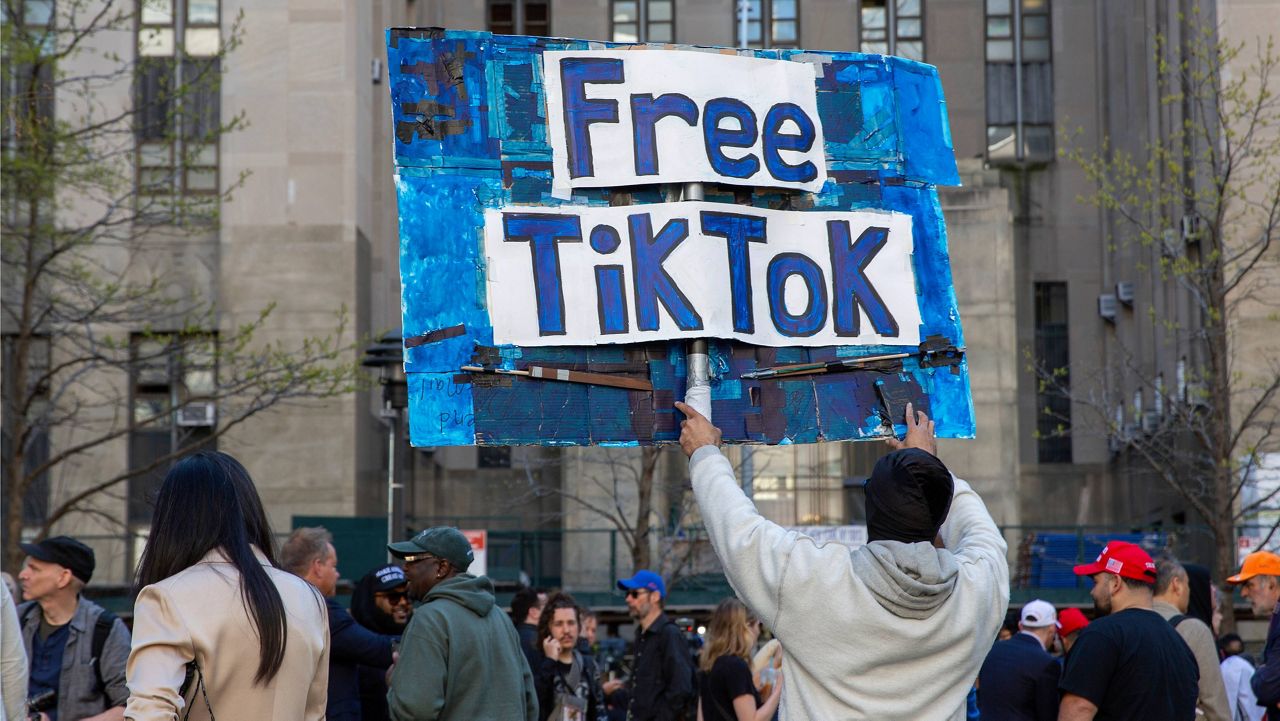 A man carries a Free TikTok sign in front of the courthouse where the hush-money trial of Donald Trump got underway April 15, 2024, in New York. (AP Photo/Ted Shaffrey, File)